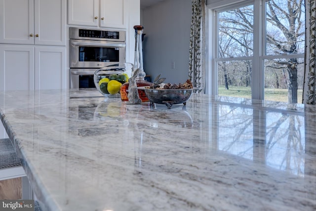 901 Riverside Ave, Grottoes, VA 24441 - kitchen with white cabinets, double oven, and light stone counters