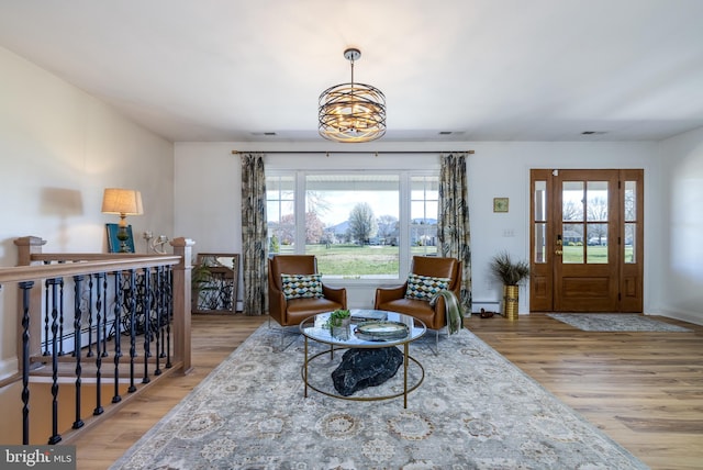 901 Riverside Ave, Grottoes, VA 24441 - living area with visible vents, a baseboard radiator, a baseboard heating unit, and wood finished floors