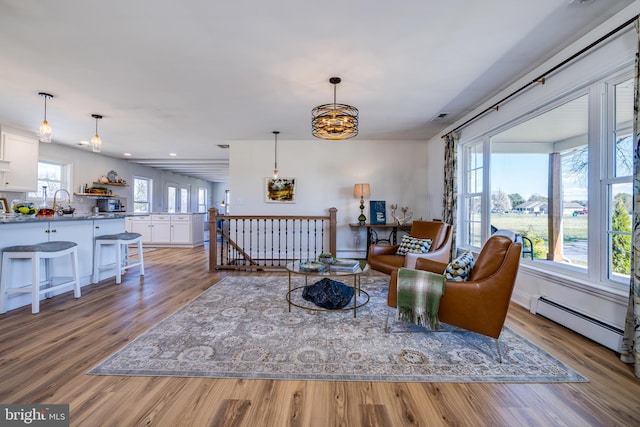 901 Riverside Ave, Grottoes, VA 24441 - living room with visible vents, recessed lighting, baseboard heating, wood finished floors, and a notable chandelier