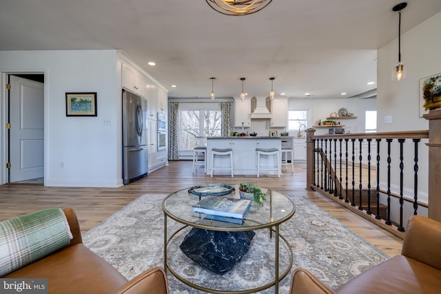 901 Riverside Ave, Grottoes, VA 24441 - living room featuring baseboards, light wood finished floors, recessed lighting, and a healthy amount of sunlight