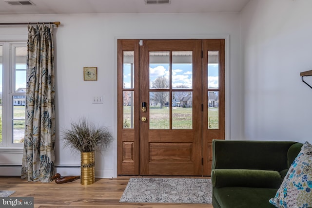 901 Riverside Ave, Grottoes, VA 24441 - foyer entrance with visible vents, a baseboard radiator, plenty of natural light, and wood finished floors