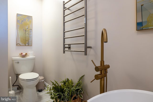 901 Riverside Ave, Grottoes, VA 24441 - half bathroom featuring toilet, baseboards, and radiator