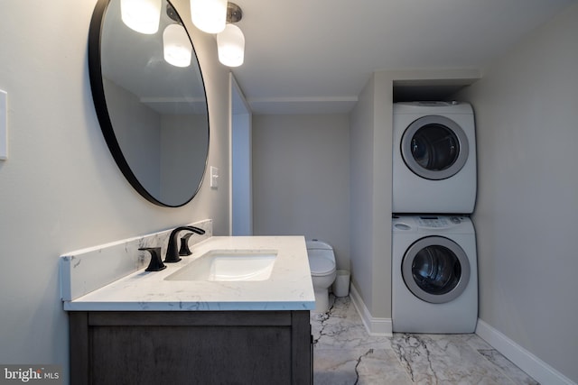 901 Riverside Ave, Grottoes, VA 24441 - bathroom with baseboards, toilet, stacked washer and dryer, vanity, and marble finish floor