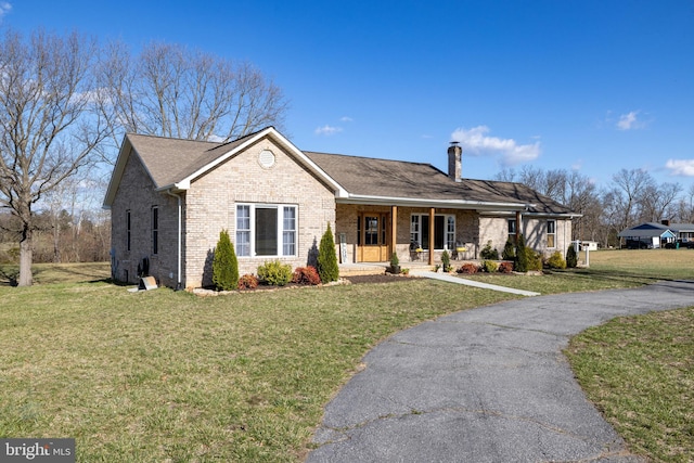 901 Riverside Ave, Grottoes, VA 24441 - single story home with a porch, a chimney, a front yard, and brick siding