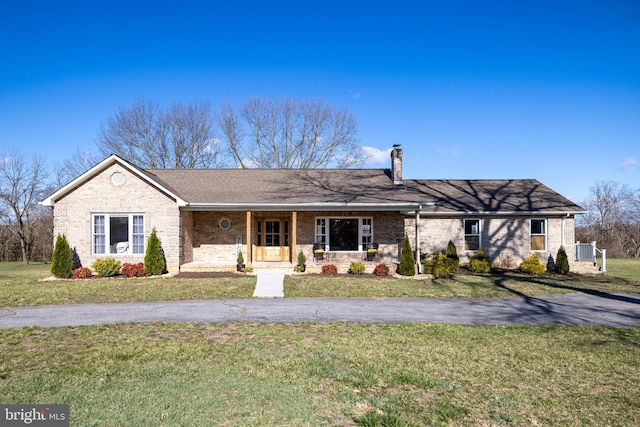 901 Riverside Ave, Grottoes, VA 24441 - single story home featuring a porch, a chimney, a front yard, and brick siding