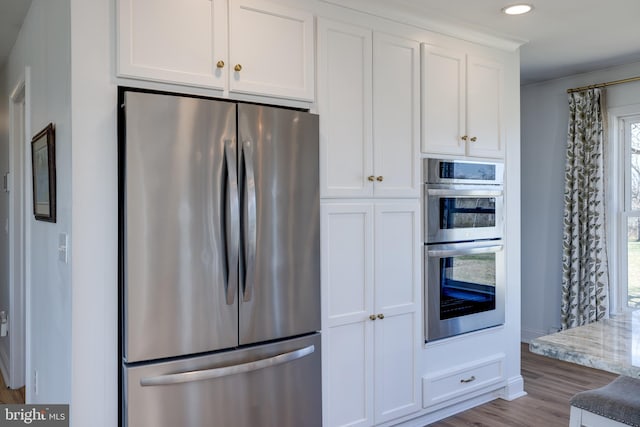 901 Riverside Ave, Grottoes, VA 24441 - kitchen with appliances with stainless steel finishes, white cabinetry, recessed lighting, wood finished floors, and light stone countertops