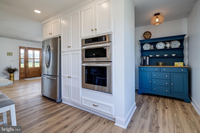 901 Riverside Ave, Grottoes, VA 24441 - kitchen with light wood-style flooring, baseboards, white cabinetry, and stainless steel appliances