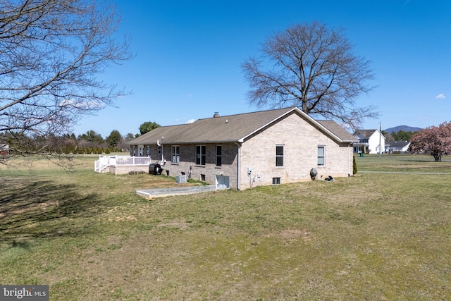 901 Riverside Ave, Grottoes, VA 24441 - back of property with brick siding, central AC unit, and a lawn