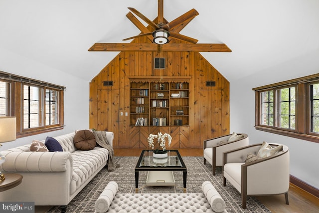 2709 Mckinley St NW, Washington, DC 20015 - living area with wood walls, ceiling fan, wood finished floors, and lofted ceiling with beams