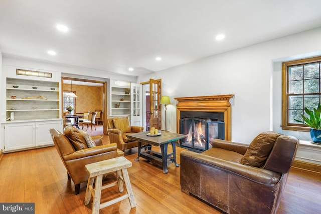 2709 Mckinley St NW, Washington, DC 20015 - living area with light wood-style flooring, a warm lit fireplace, and recessed lighting