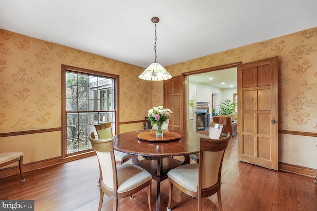 2709 Mckinley St NW, Washington, DC 20015 - dining space featuring wallpapered walls, light wood finished floors, baseboards, and a fireplace