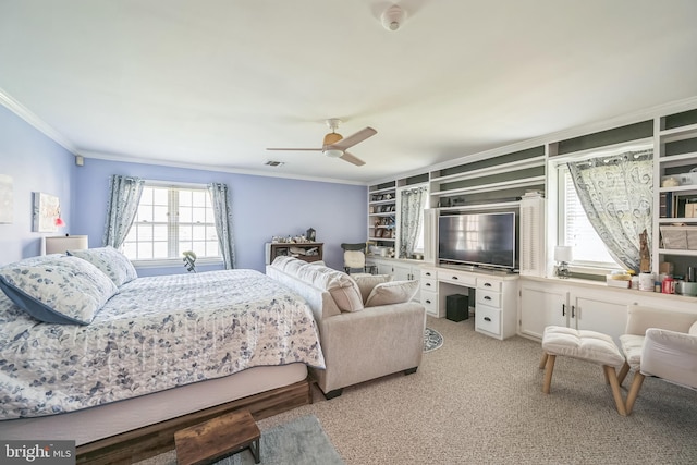 bedroom featuring light carpet, crown molding, and ceiling fan