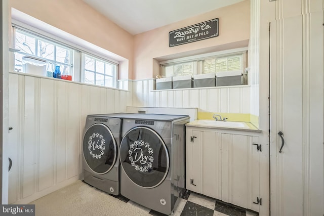 laundry area with washer and dryer and a sink