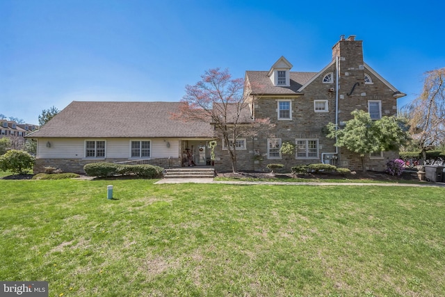 view of front facade featuring a chimney and a front lawn