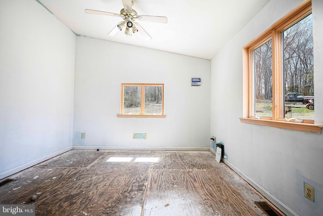 spare room with baseboards, a ceiling fan, and visible vents