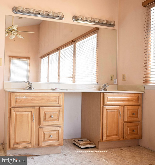 kitchen with light countertops, a healthy amount of sunlight, a ceiling fan, and light tile patterned floors
