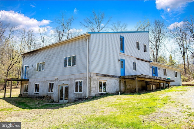 rear view of house with french doors, a yard, central AC, and a deck
