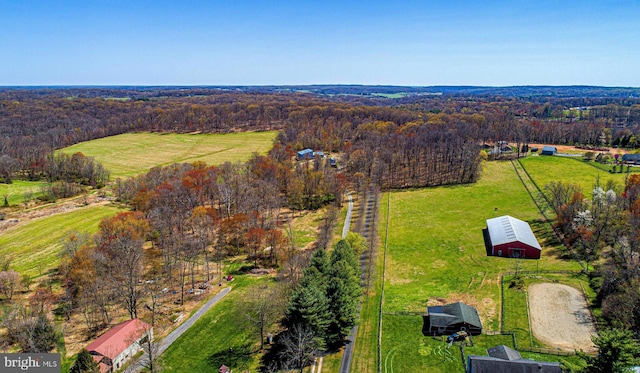 aerial view featuring a rural view and a wooded view