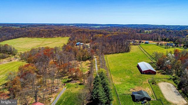 aerial view featuring a rural view and a wooded view