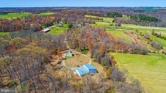 aerial view featuring a rural view and a wooded view