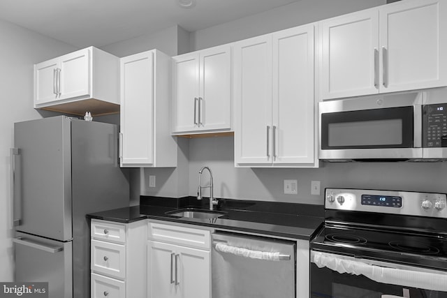 3417 Edmondson Ave, Baltimore, MD 21229 - kitchen featuring white cabinets, dark countertops, a sink, and appliances with stainless steel finishes