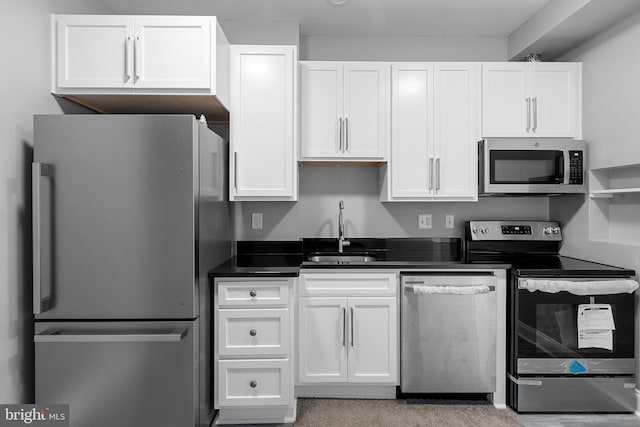 3417 Edmondson Ave, Baltimore, MD 21229 - kitchen featuring dark countertops, white cabinetry, stainless steel appliances, and a sink