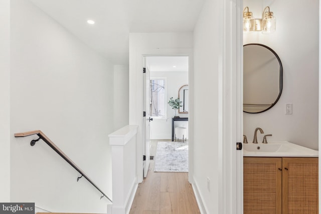 bathroom with recessed lighting, vanity, and wood finished floors
