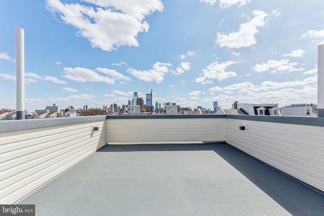 view of patio with a view of city and a balcony