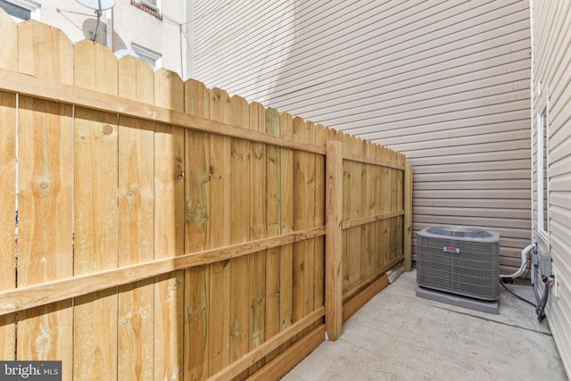 details featuring fence and central air condition unit