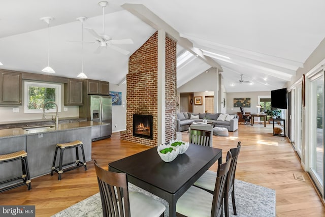 3 Steffen Point Hts, Annapolis, MD 21401 - dining space with a ceiling fan, healthy amount of natural light, beam ceiling, a brick fireplace, and light wood-type flooring