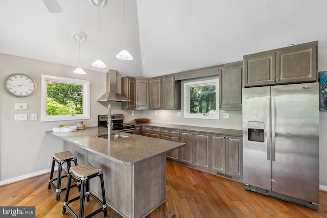 3 Steffen Point Hts, Annapolis, MD 21401 - kitchen featuring appliances with stainless steel finishes, wall chimney exhaust hood, a peninsula, a breakfast bar, and plenty of natural light