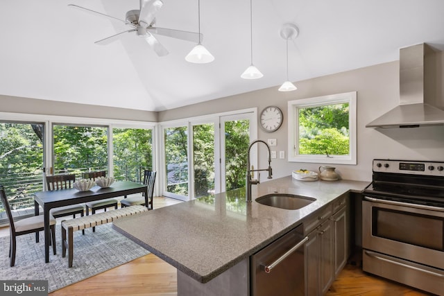 3 Steffen Point Hts, Annapolis, MD 21401 - kitchen featuring appliances with stainless steel finishes, wall chimney range hood, a peninsula, light stone countertops, and vaulted ceiling