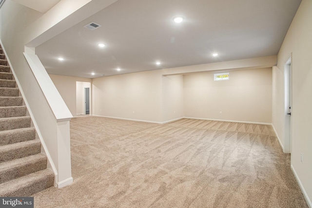 basement featuring visible vents, recessed lighting, carpet floors, and stairs