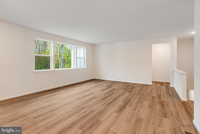 unfurnished room featuring light wood-type flooring and baseboards