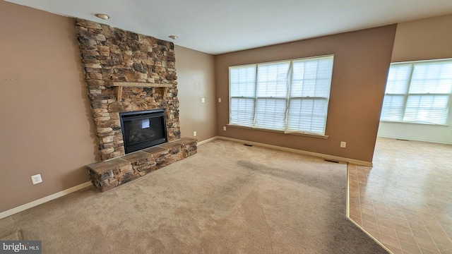5502 Frankford Estates Dr, Baltimore, MD 21206 - unfurnished living room with plenty of natural light, carpet flooring, a stone fireplace, and baseboards
