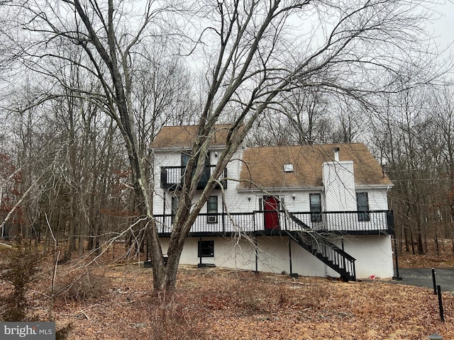 1076 Lancaster Dr, Bushkill, PA 18324 - view of front of property with a chimney, a deck, and stairs