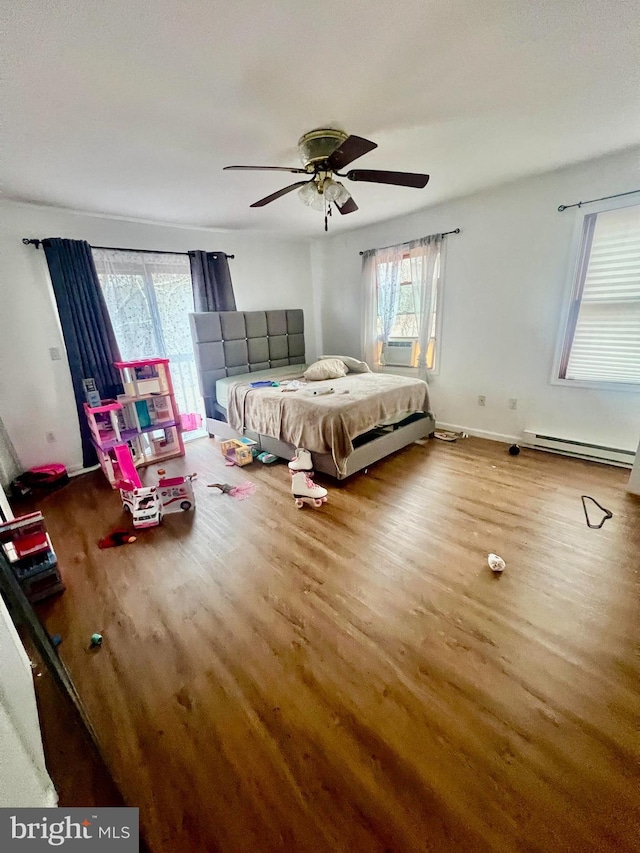 1076 Lancaster Dr, Bushkill, PA 18324 - bedroom featuring a baseboard heating unit, baseboards, a ceiling fan, and wood finished floors