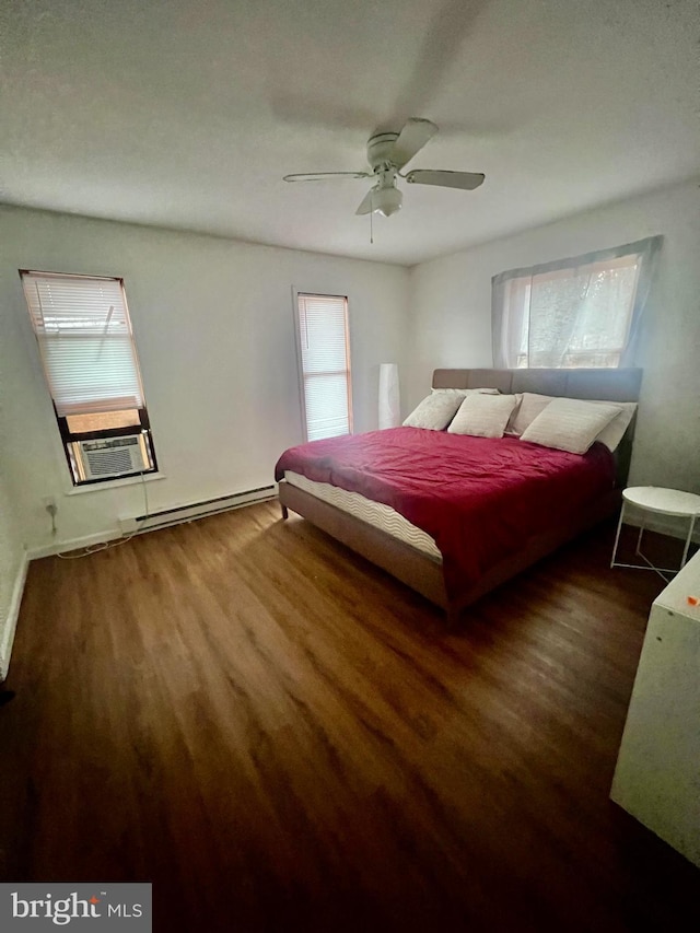 1076 Lancaster Dr, Bushkill, PA 18324 - bedroom featuring baseboard heating, wood finished floors, ceiling fan, and baseboards