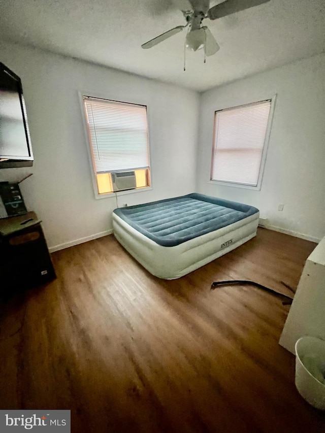 1076 Lancaster Dr, Bushkill, PA 18324 - bedroom with baseboards, multiple windows, cooling unit, and wood finished floors