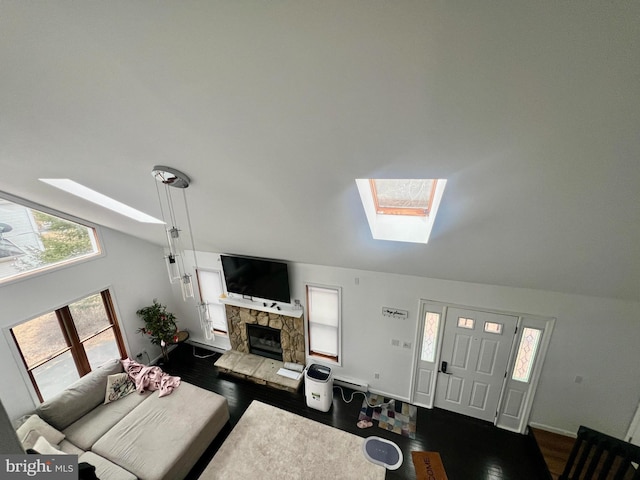 1076 Lancaster Dr, Bushkill, PA 18324 - living room featuring dark wood-type flooring, a skylight, high vaulted ceiling, and a fireplace