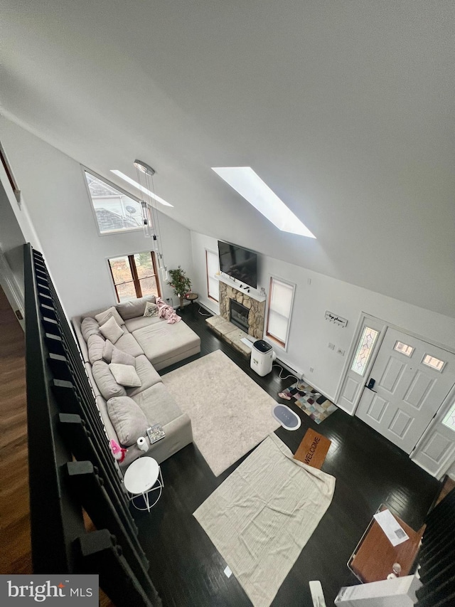 1076 Lancaster Dr, Bushkill, PA 18324 - living area featuring vaulted ceiling with skylight, stairs, wood finished floors, and a fireplace