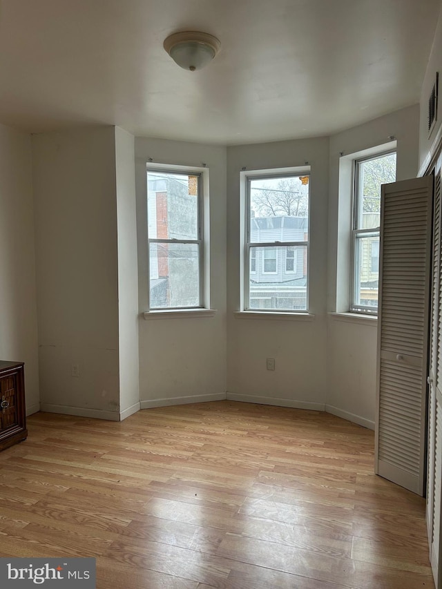 unfurnished bedroom featuring light wood-style floors and baseboards
