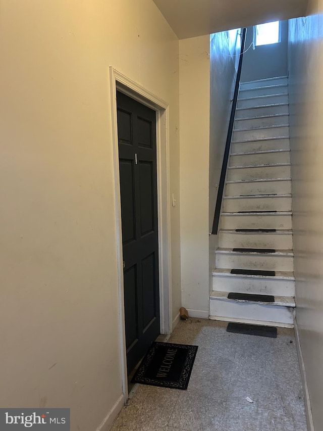 stairs featuring baseboards