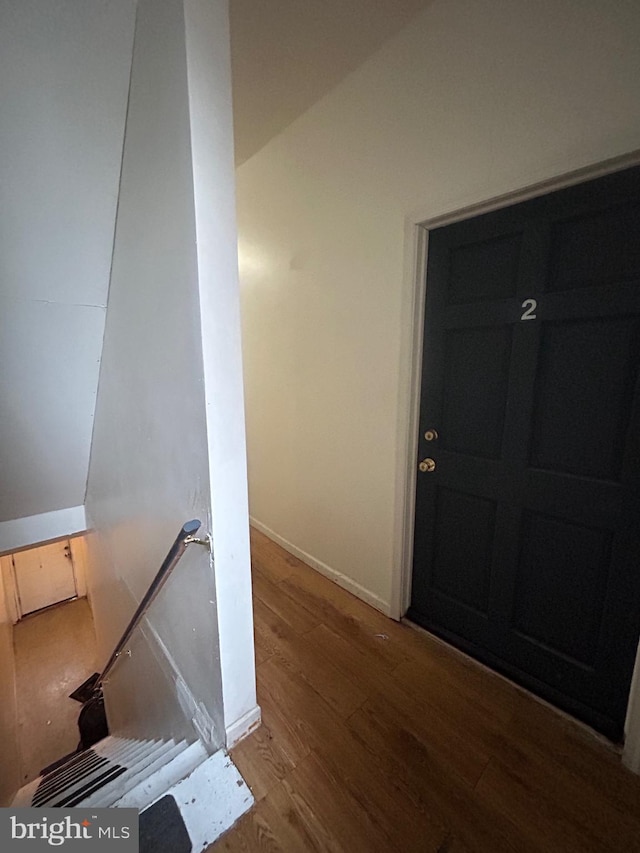 interior space with baseboards and wood finished floors