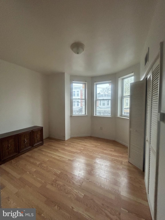 interior space with light wood-style flooring and visible vents