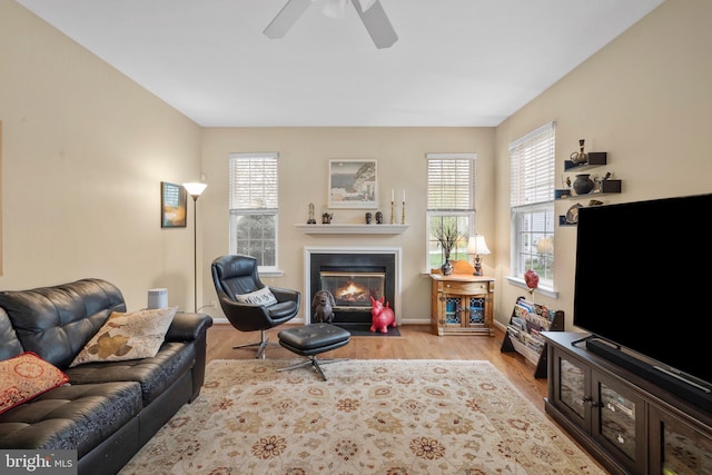 822 Rhinehart Ln, Phoenixville, PA 19460 - living room featuring wood finished floors, a fireplace with flush hearth, a ceiling fan, and baseboards