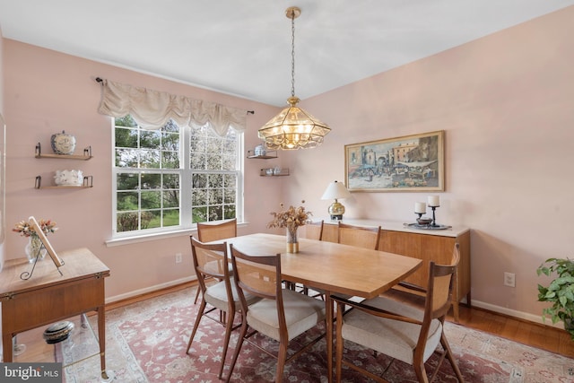 822 Rhinehart Ln, Phoenixville, PA 19460 - dining room with a chandelier, baseboards, and light wood-style floors