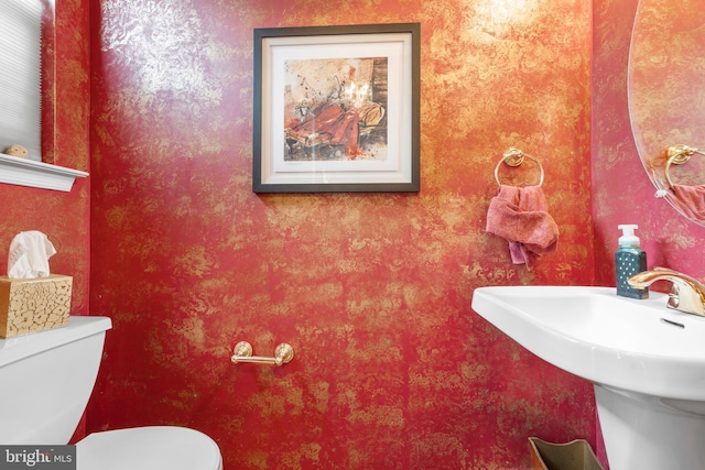 822 Rhinehart Ln, Phoenixville, PA 19460 - half bathroom featuring toilet, a sink, and wallpapered walls