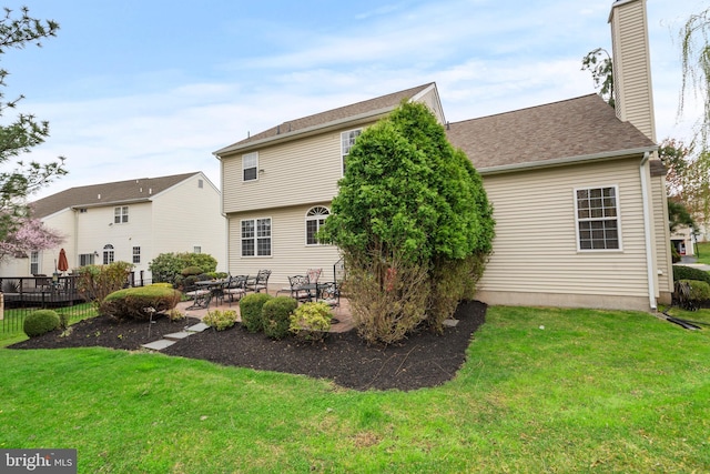 822 Rhinehart Ln, Phoenixville, PA 19460 - rear view of property featuring a chimney, a lawn, a patio, and roof with shingles