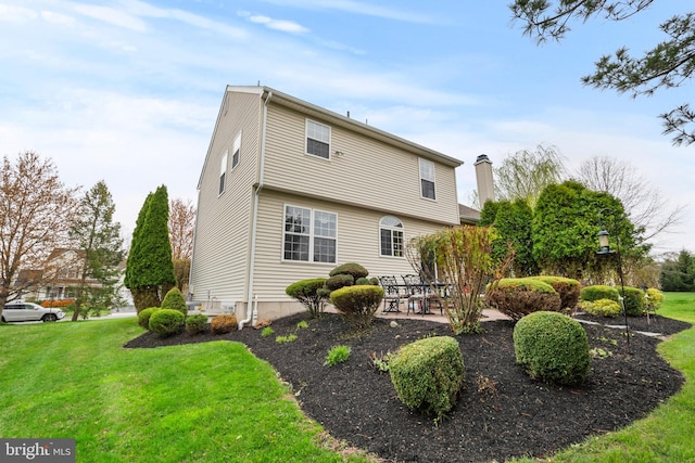 822 Rhinehart Ln, Phoenixville, PA 19460 - rear view of house featuring a yard, a patio area, and a chimney
